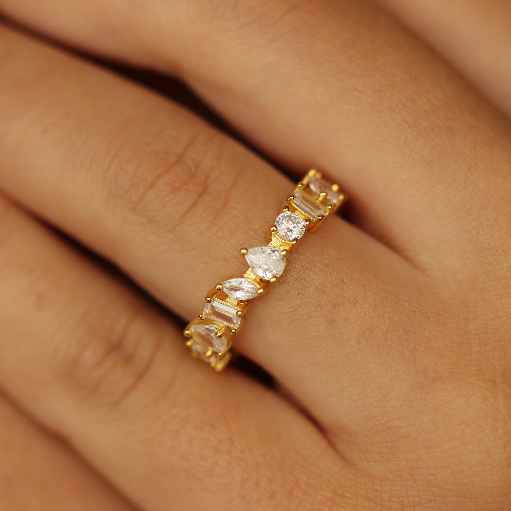 Gold eternity ring marquise, round, and emerald cut stone 