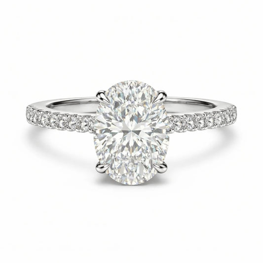 oval moissanite ring with pave band and hidden halo on white background
