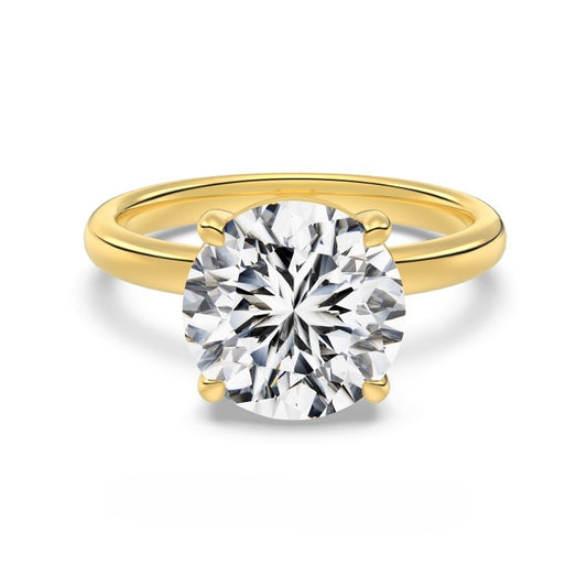 4 carat round cut gold ring on white background