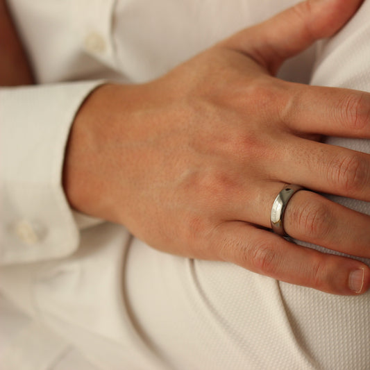 Male model with hands crossed wearing Men’s Polished Silver Wedding Band 6mm