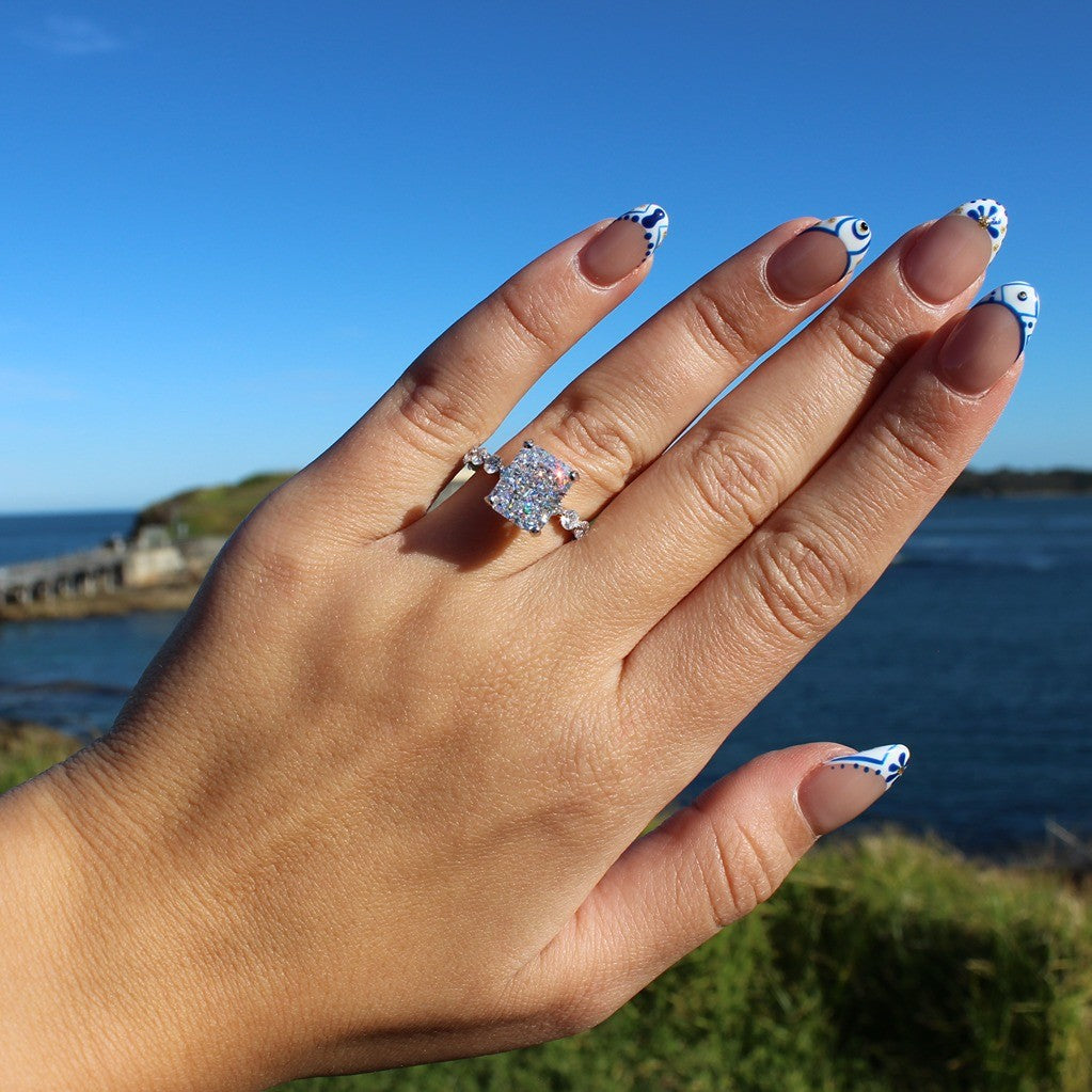 Radiant rectangle ring on hand at La Perouse Beach, Sydney