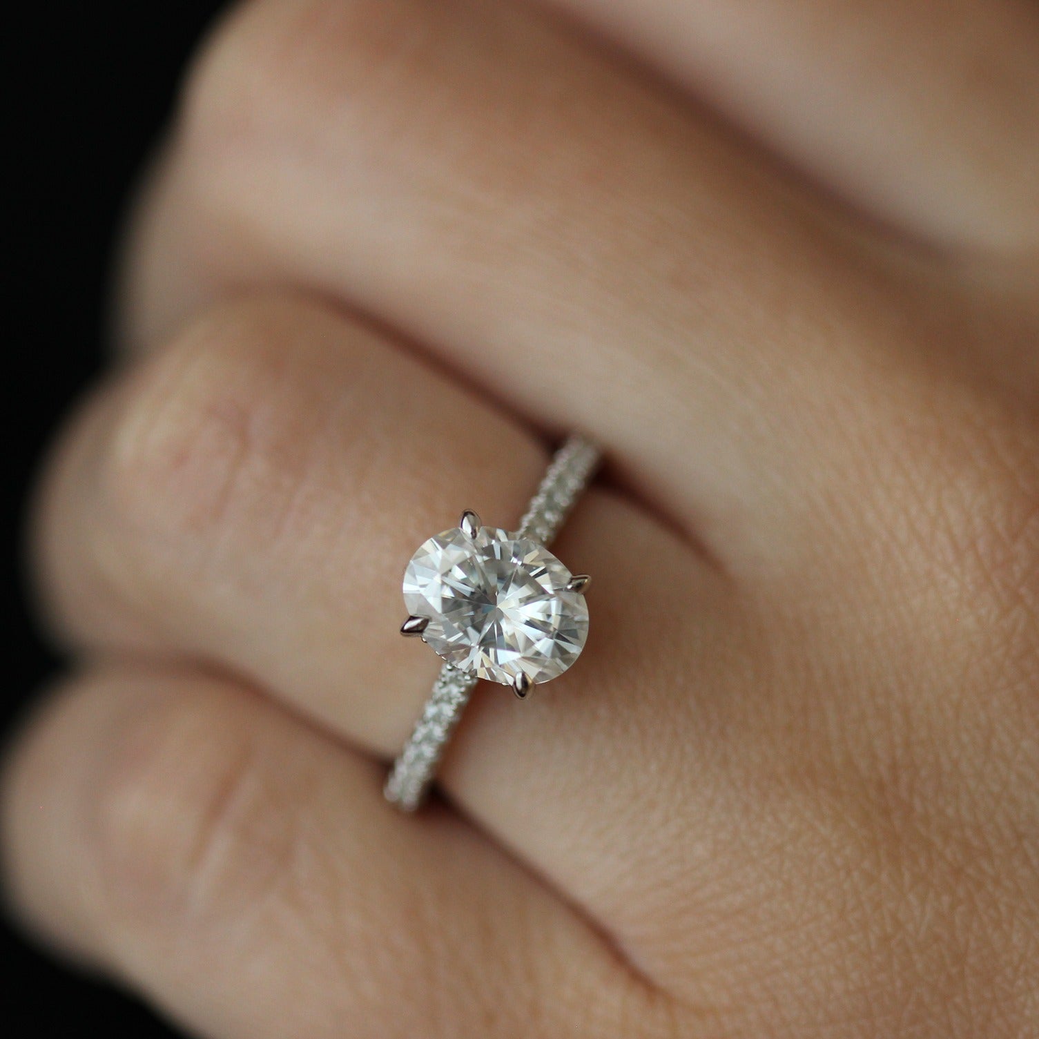2ct oval moissanite ring with pave band on hand