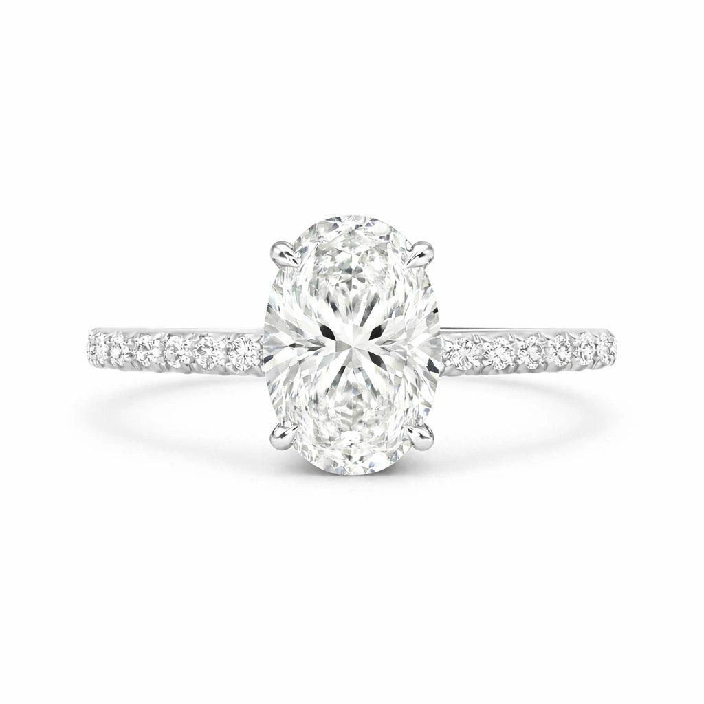 2 carat oval moissanite ring with pave band on white background