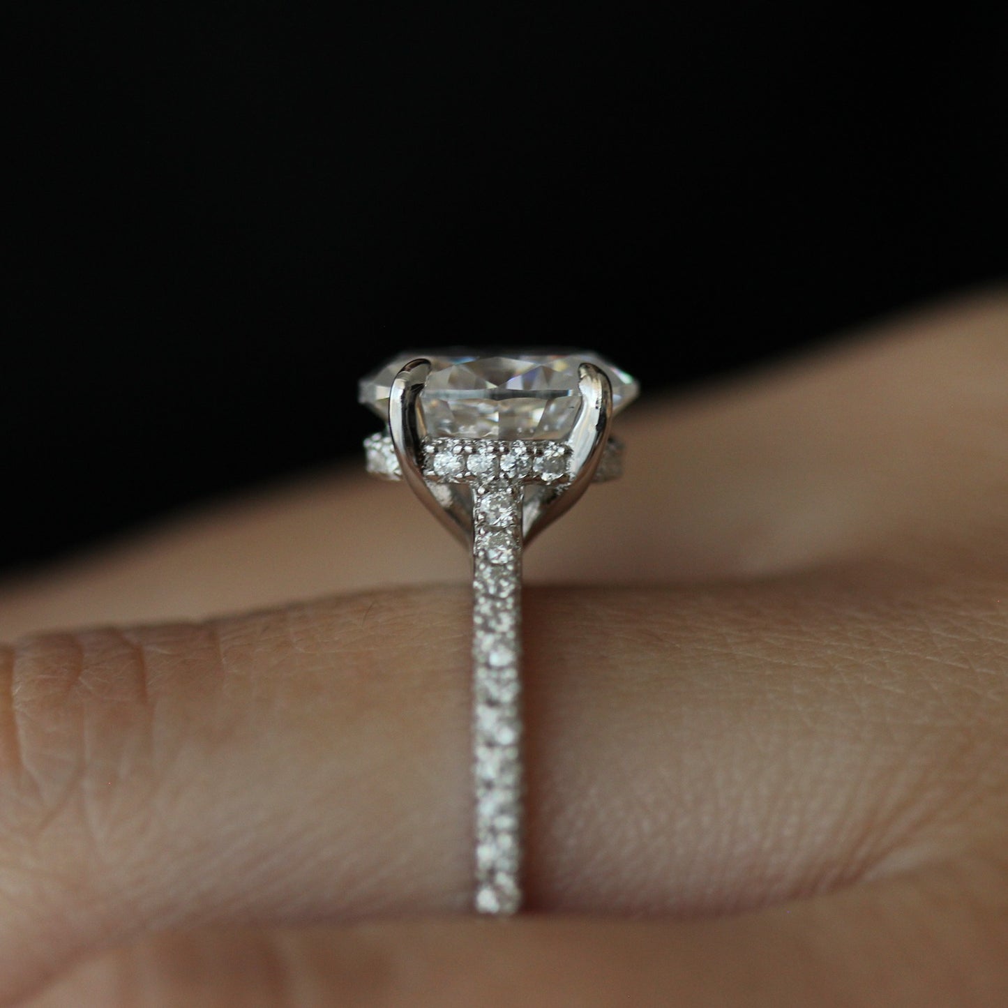 Side view of 3ct oval moissanite ring with pave band
