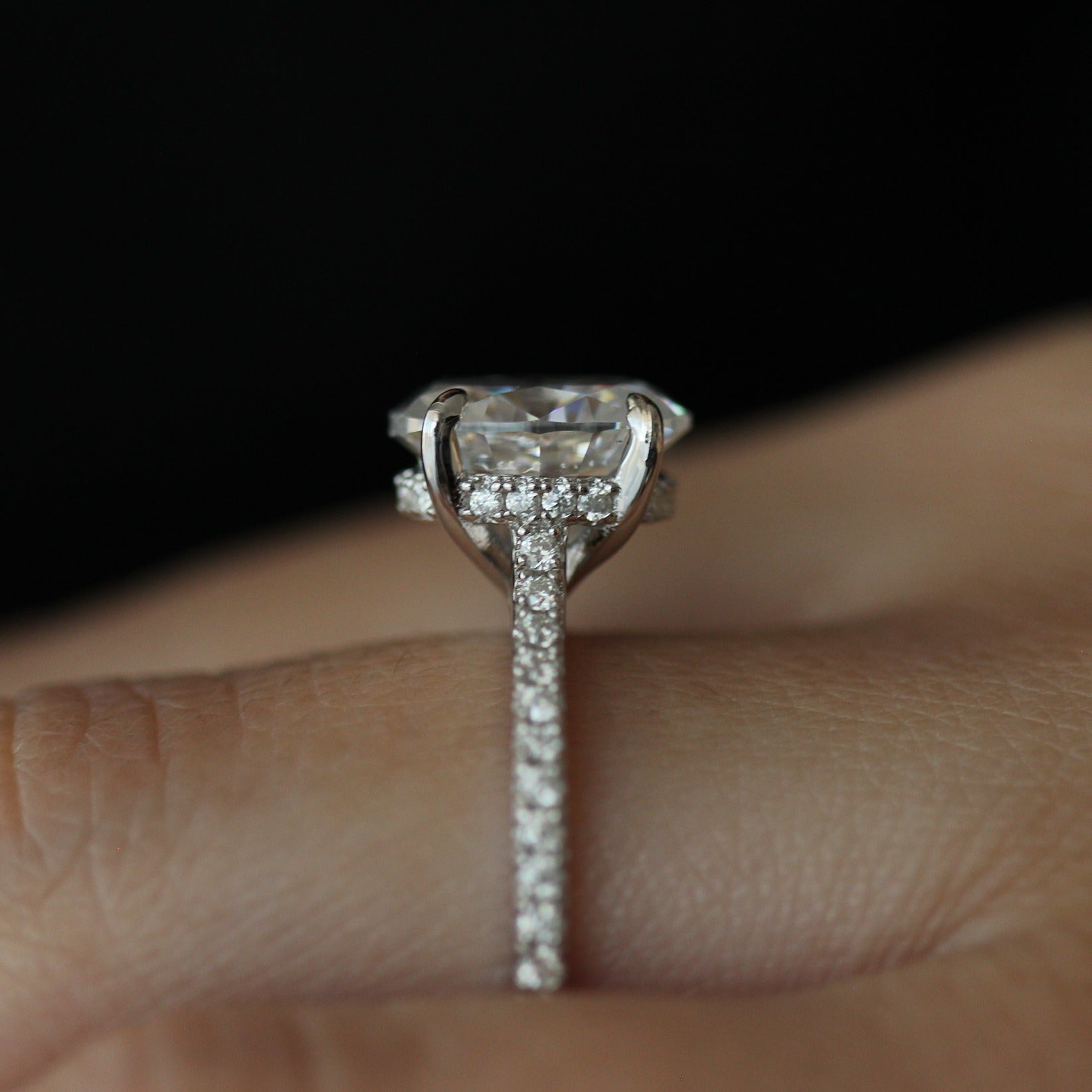 Side view of 3ct oval moissanite ring with pave band