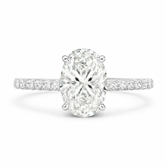 moissanite oval ring with 3 ct gemstone and moissanite pave band against a white background