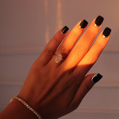 3.5ct oval gold ring on hand with gold tennis bracelet