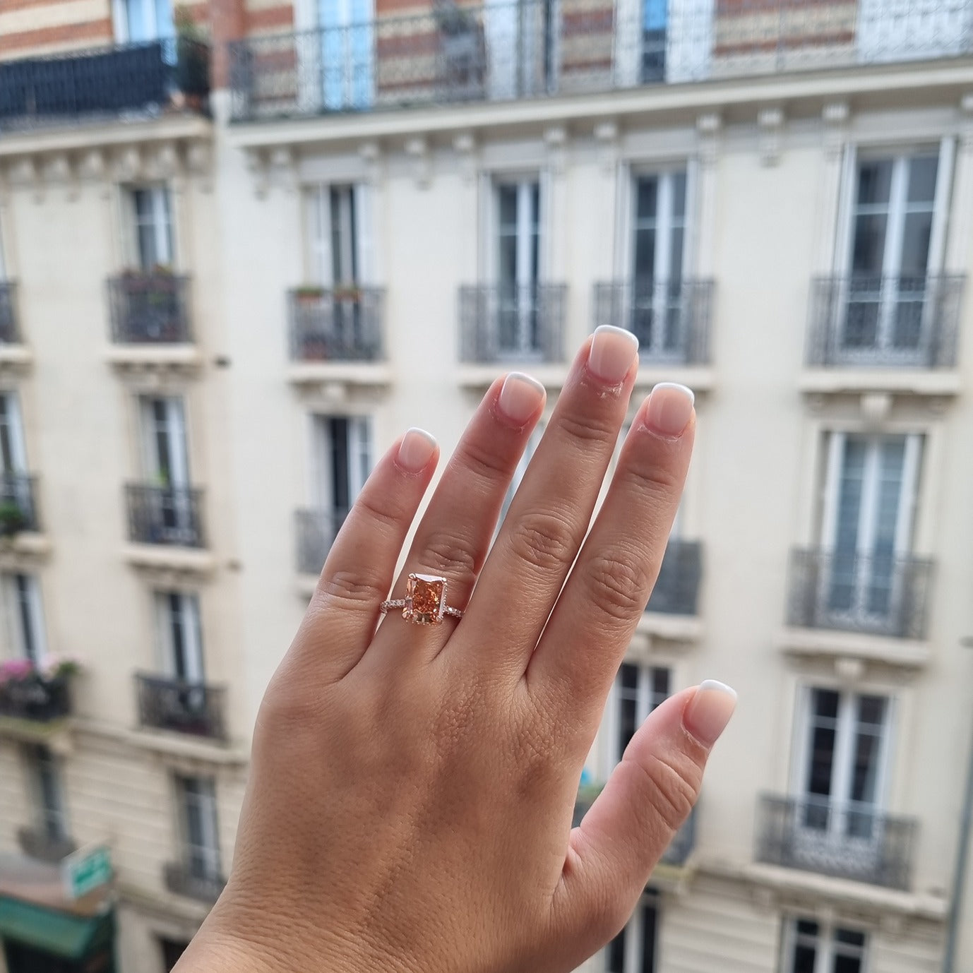 Rose gold radiant ring on hand in Paris