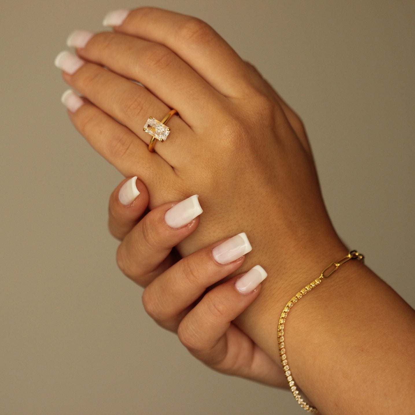 18k gold vermeil ring on hand with gold tennis bracelet