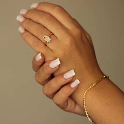 18k gold vermeil ring on hand with gold tennis bracelet