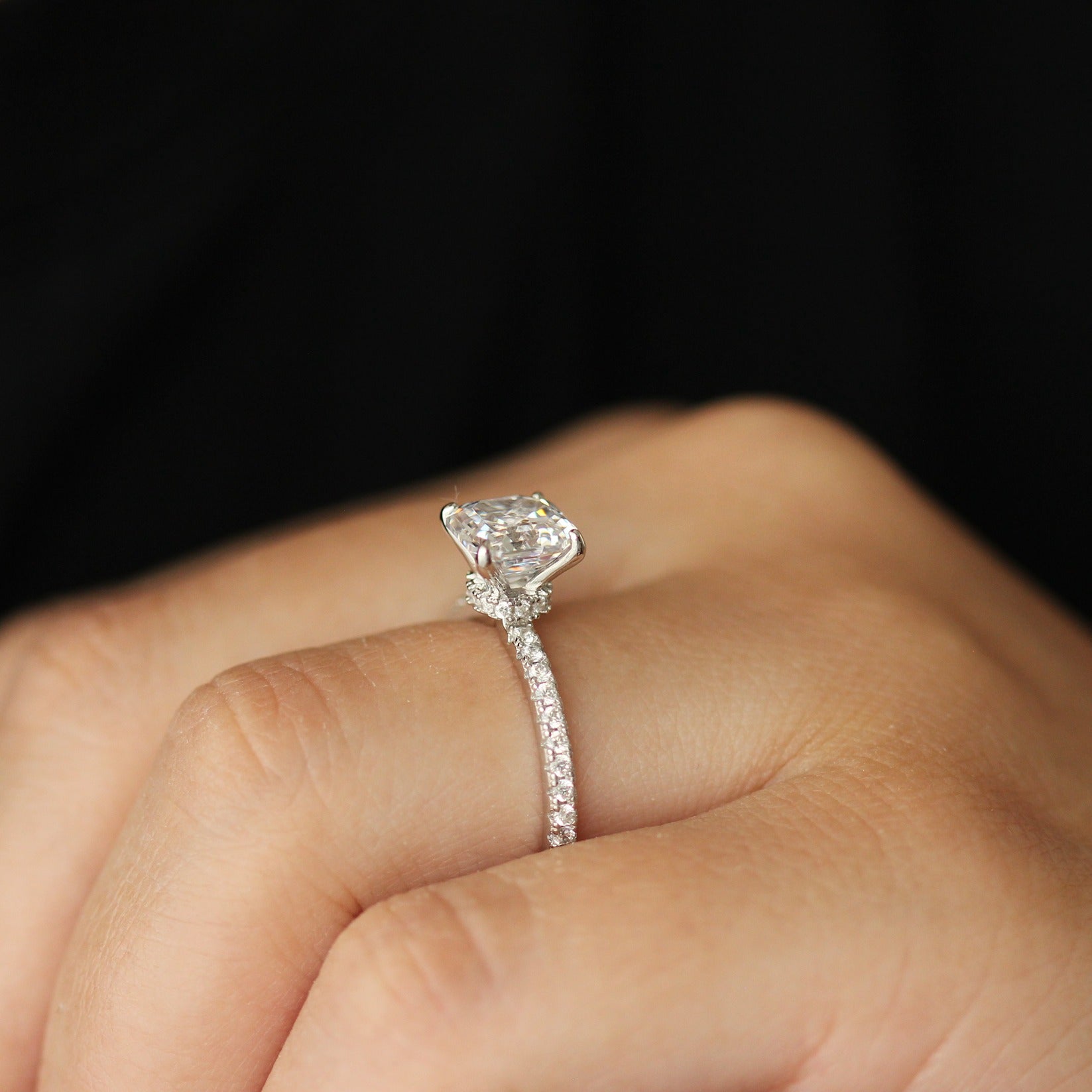 side view of Cubic zirconia ring with asscher cut centre stone and pave band on hand