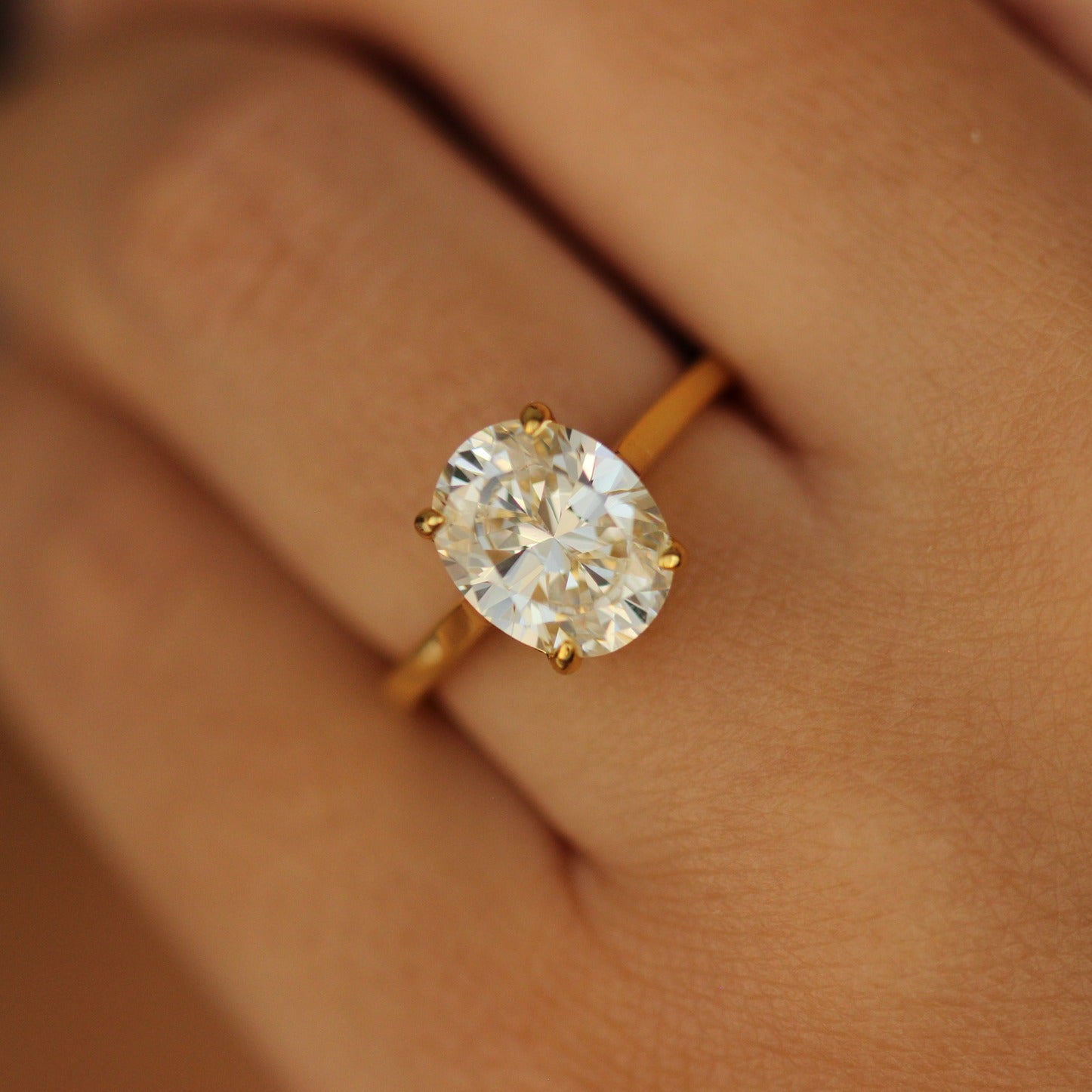 3 carat solitaire Oval gold ring on hand