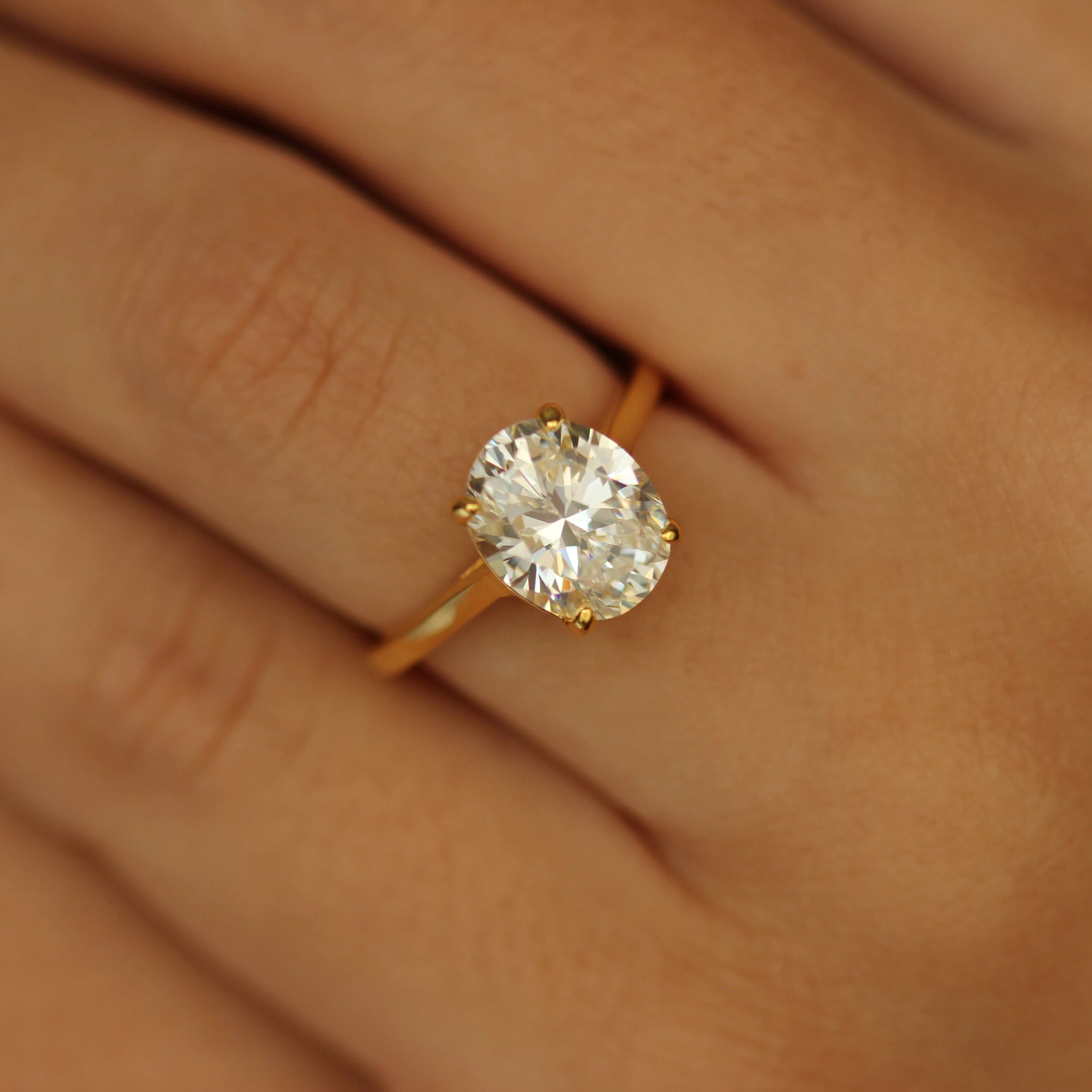 3 ct oval ring with gold band on hand