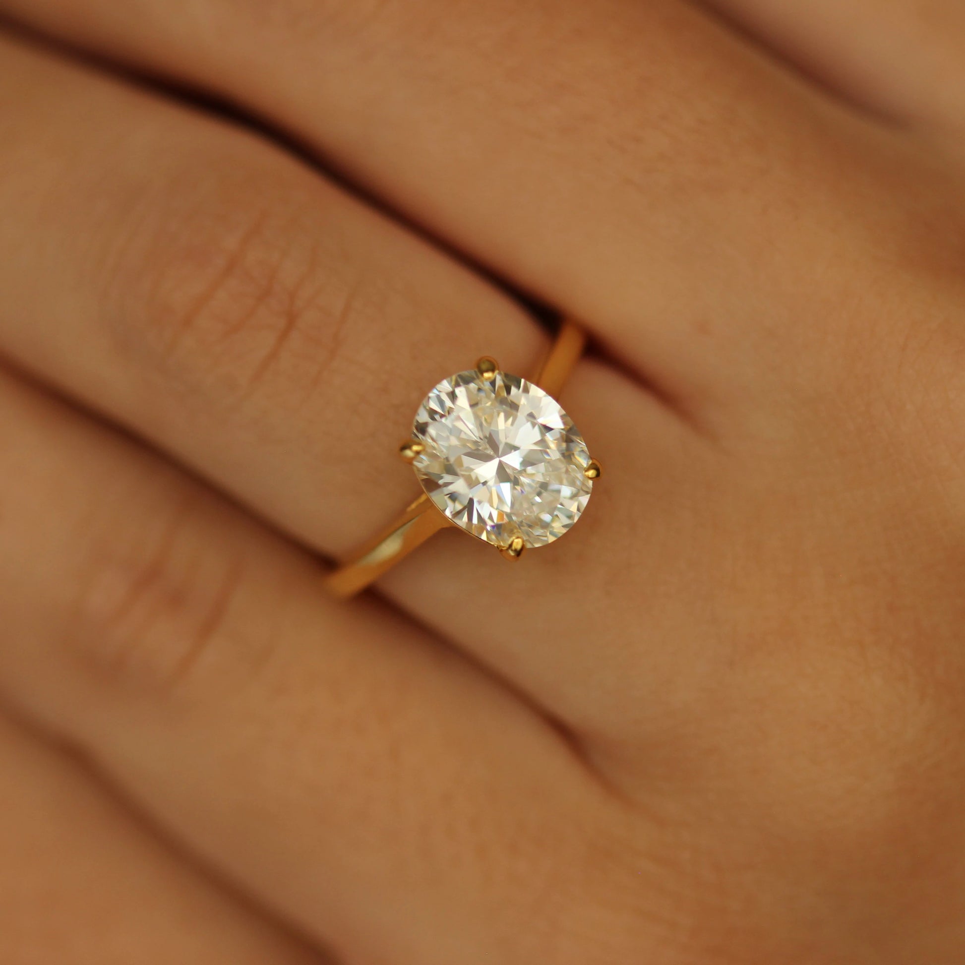 3 ct oval ring with gold band on hand