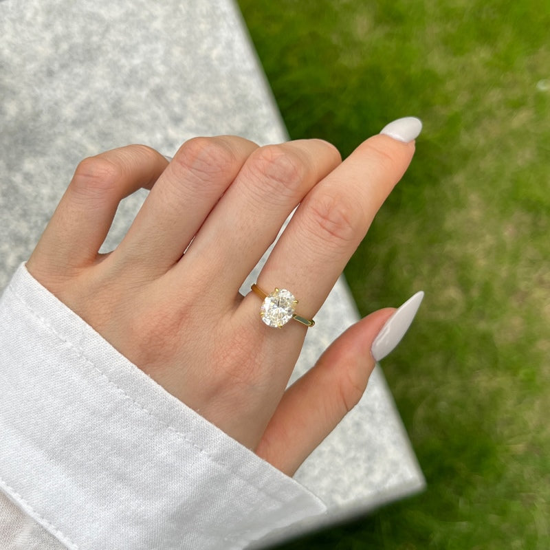 women posing with her hands showing her oval gold ring