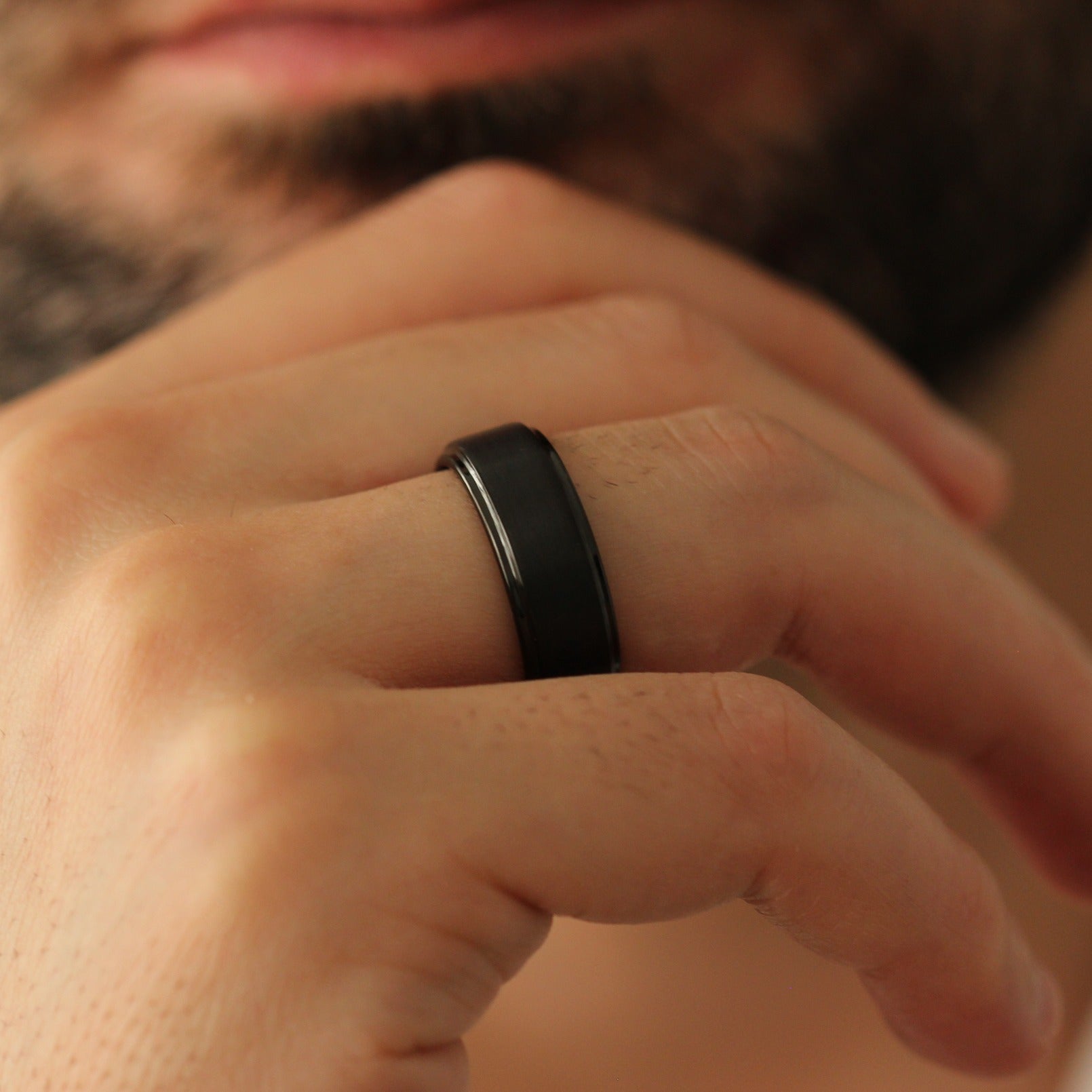 Male model chin pose wearing Black Men’s Ring 8mm with stepped edge