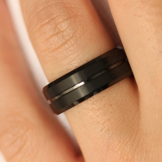 black tungsten men's wedding ring with centre groove worn on hand