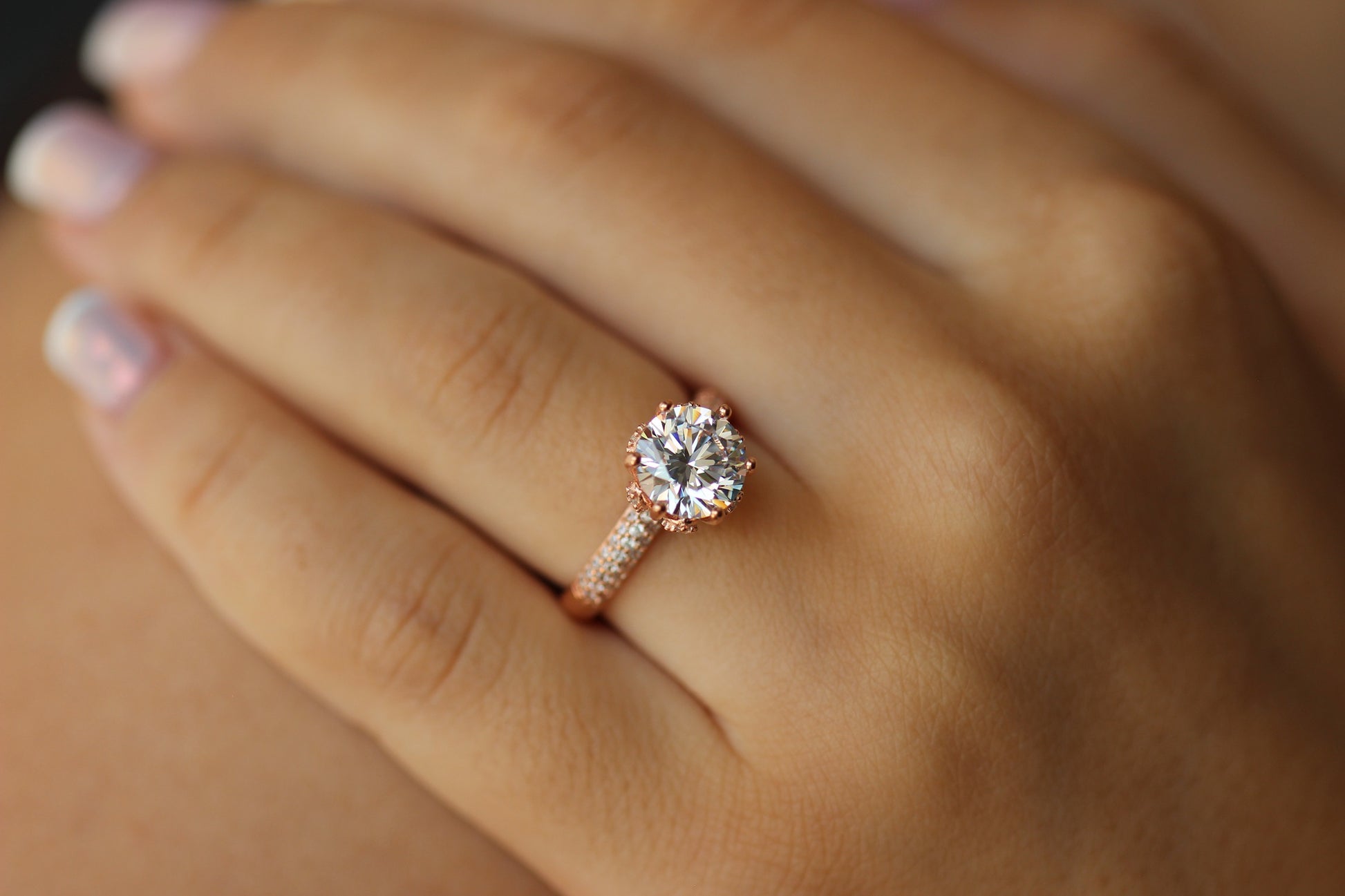 rose gold ring with round stone centre with cubic zirconia stones on band