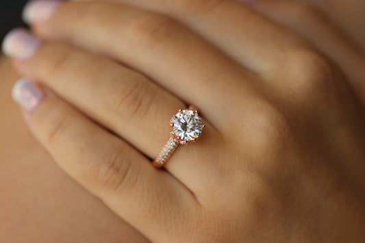 rose gold ring with round stone centre with cubic zirconia stones on band