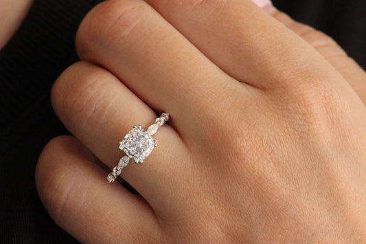 silver ring with square centre stone with a radiant cut