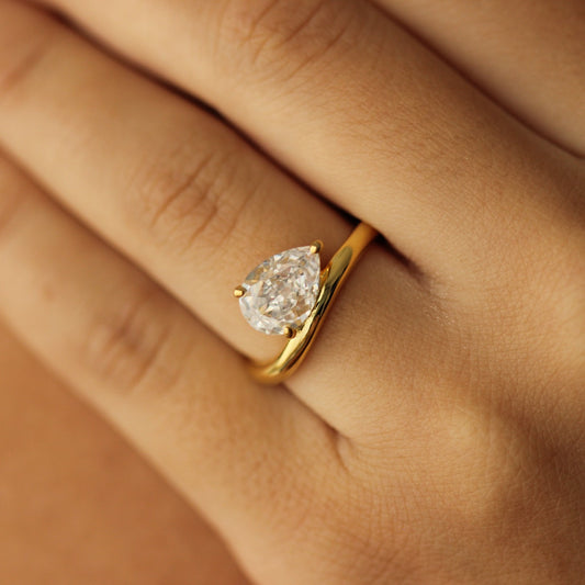 east west facing curved pear ring in gold