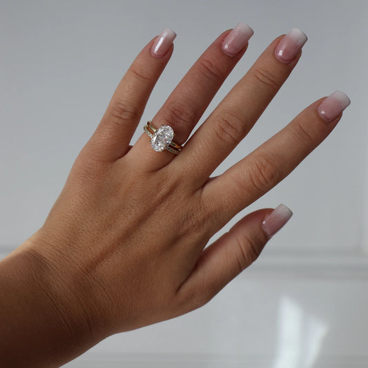 14k gold oval ring and 14k half eternity pave band on hand