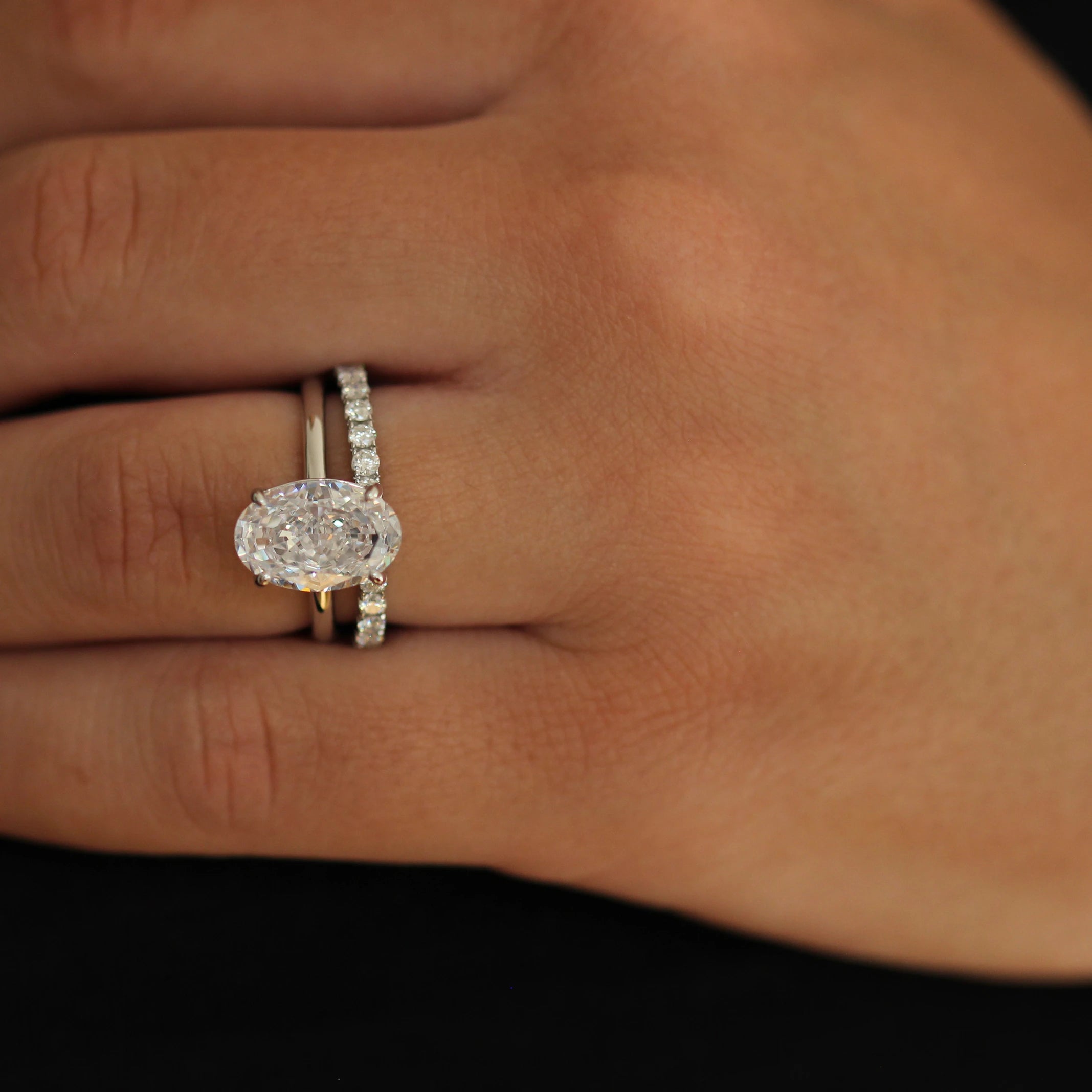 Elongated cubic zirconia silver oval ring stacked with eternity band