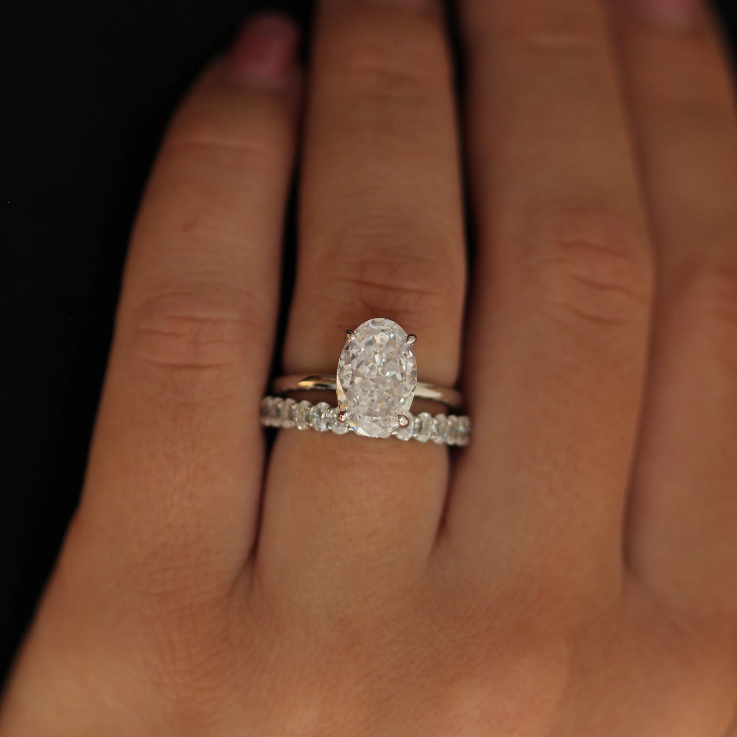 Silver oval ring with elongated cubic zirconia stone paired with eternity band
