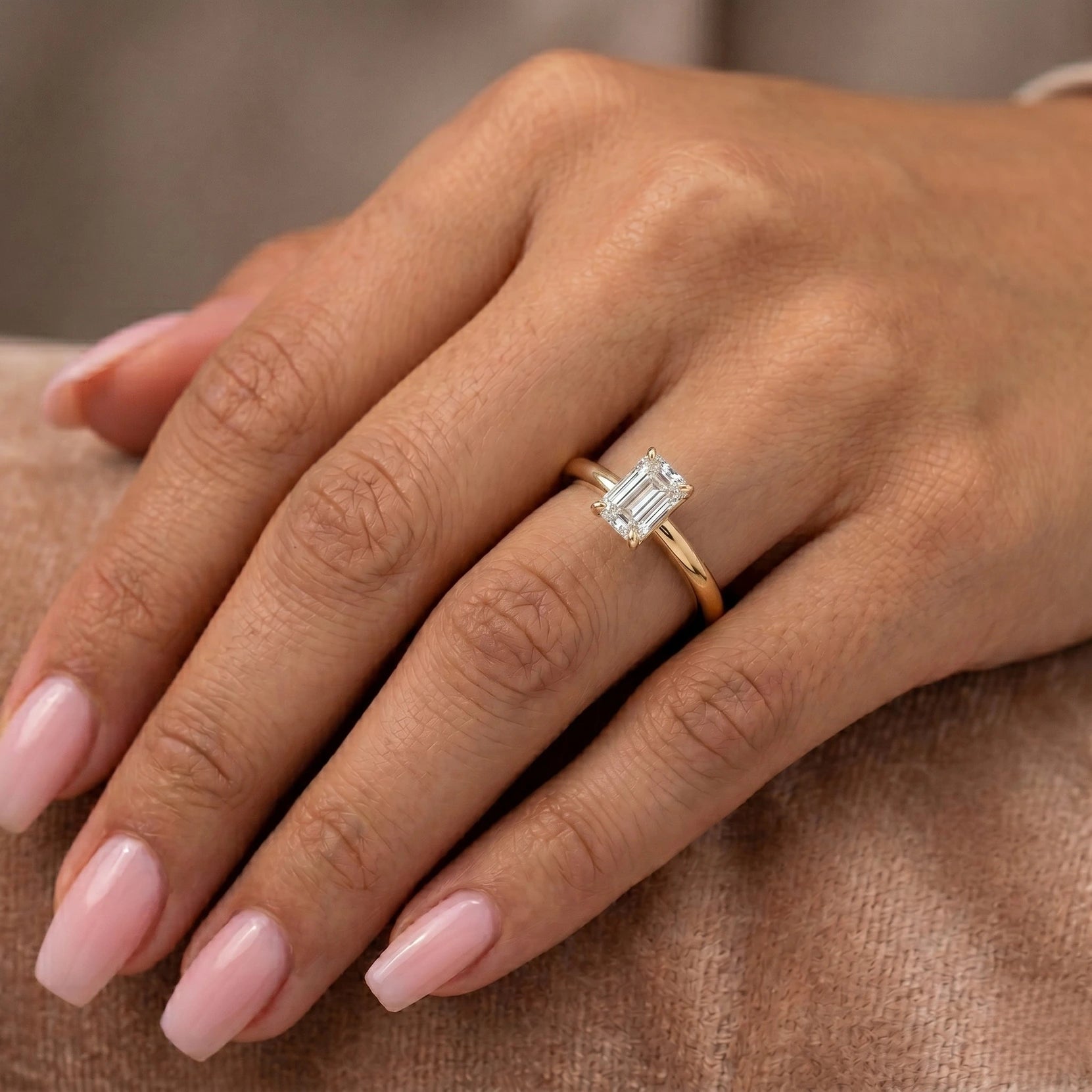 emerald cut lab grown diamond engagement ring on model hand