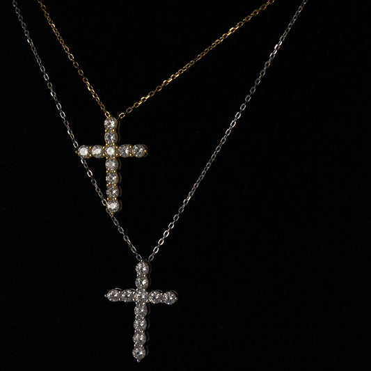 gold cross necklace next to silver necklace