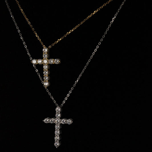 gold cross necklace next to a silver cross necklace