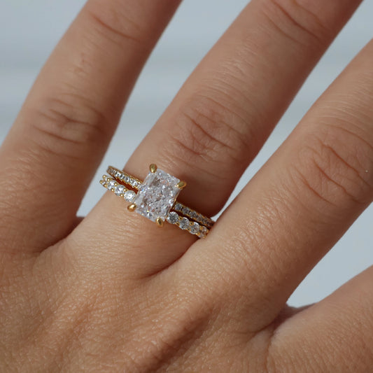 Gold 2 ct radiant cut CZ ring featuring pavé band