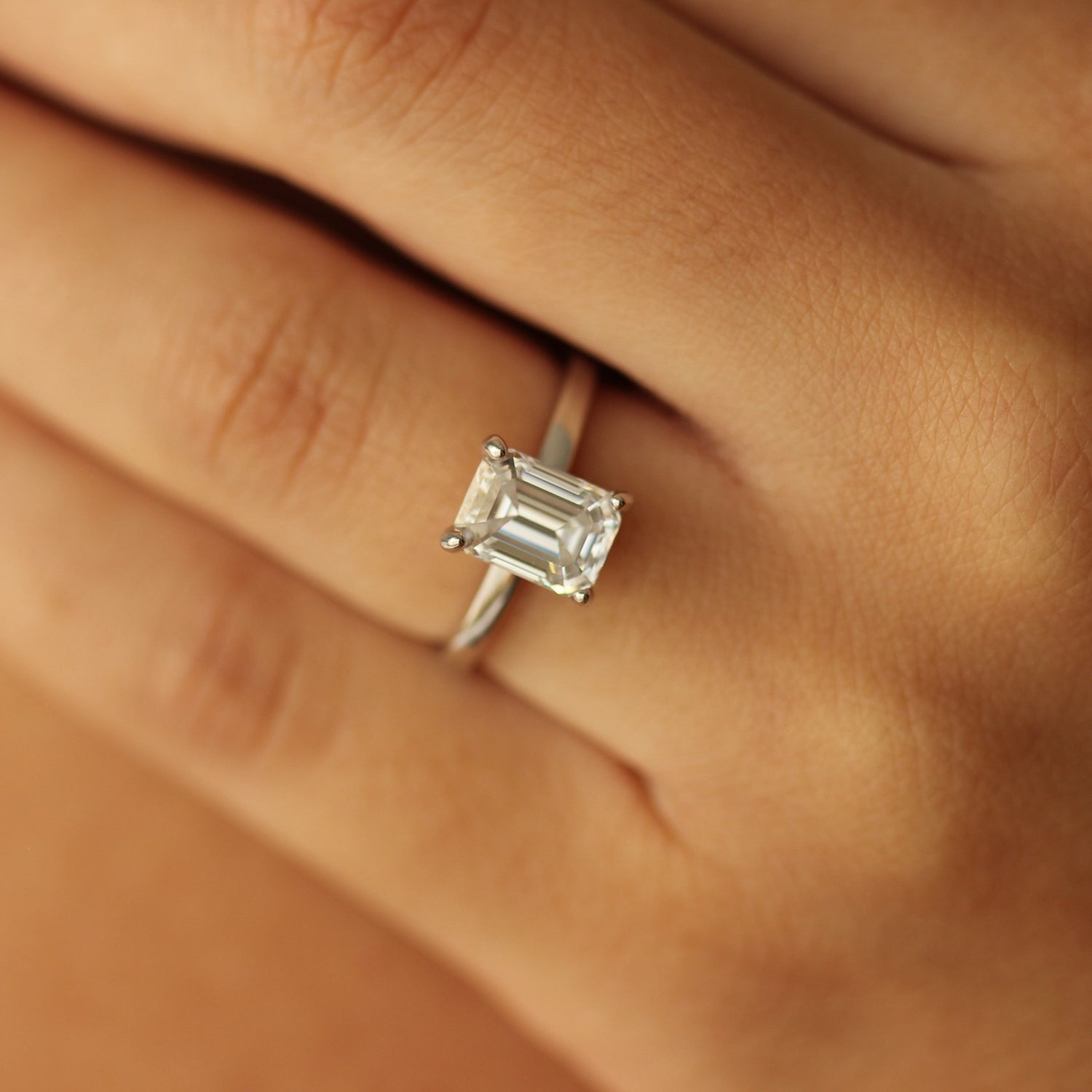 plain silver band with 2 carat moissanite centre stone on hand