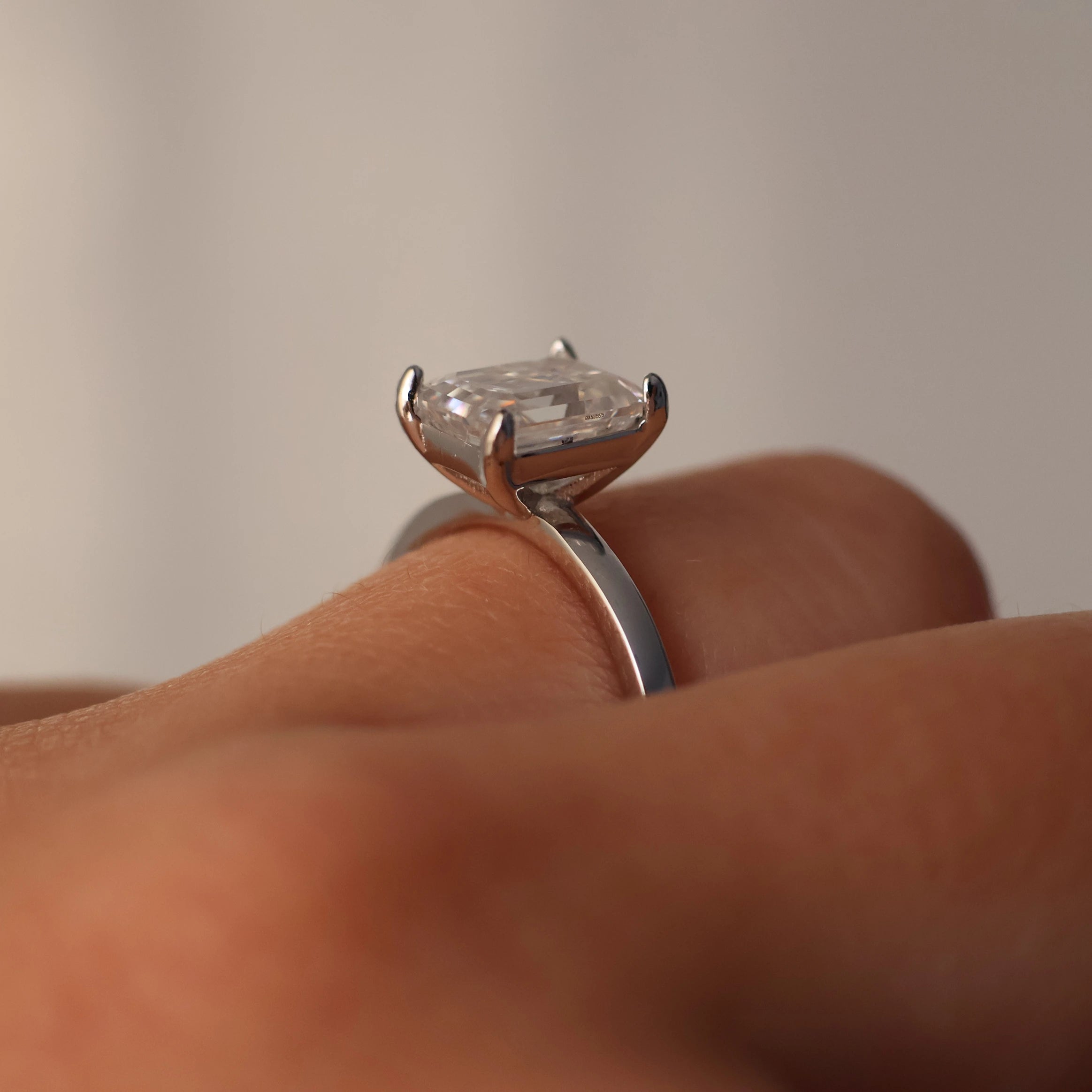 side view of emerald cut moissanite ring