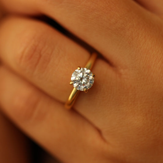 Gold round ring on hand
