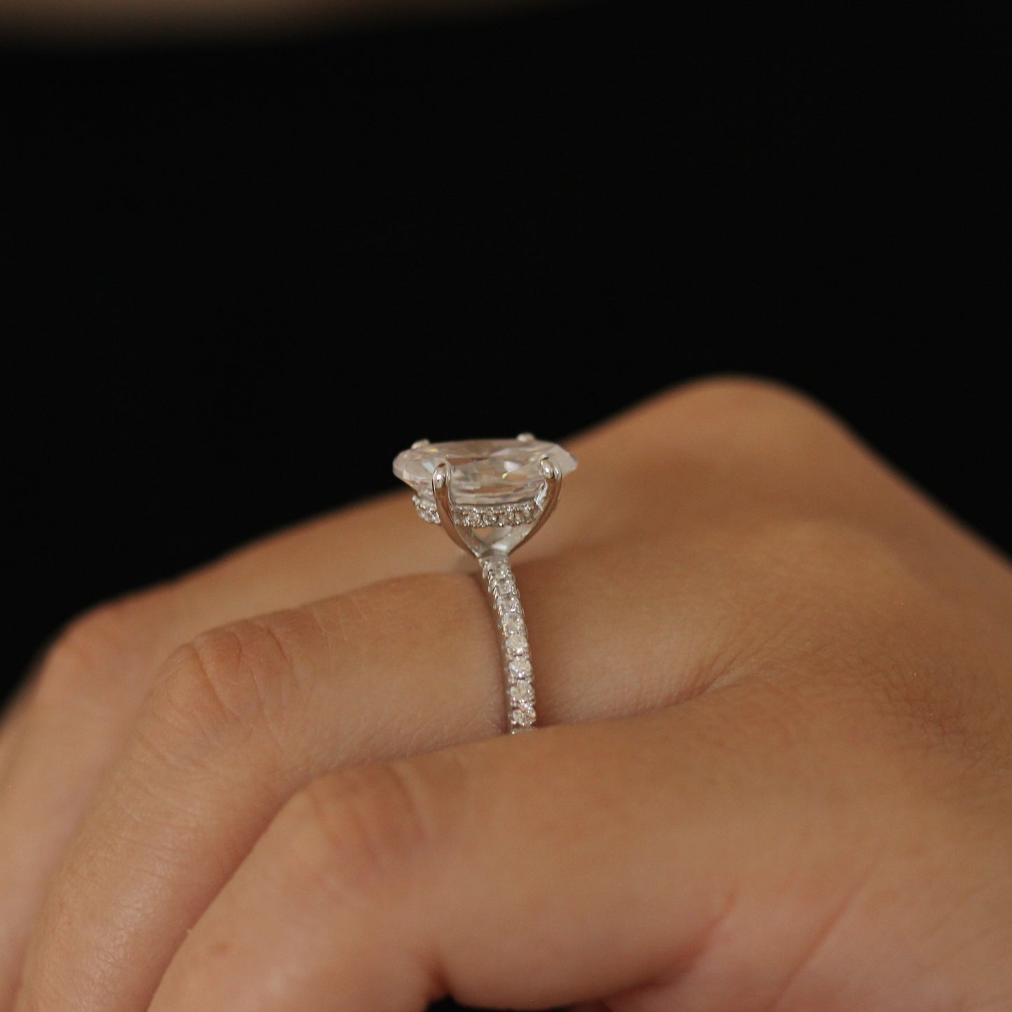 3.5 carat silver oval ring on half pave band side angle