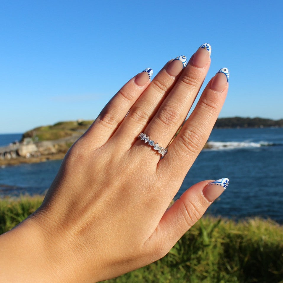Silver cubic zirconia stacker ring on hand at La Perouse Beach, Sydney