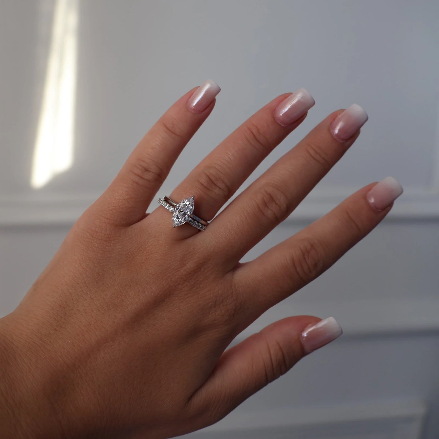 Silver marquise solitaire ring worn on hand