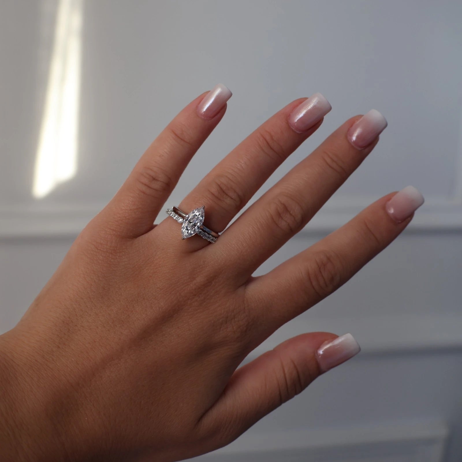 Silver marquise solitaire ring worn on hand