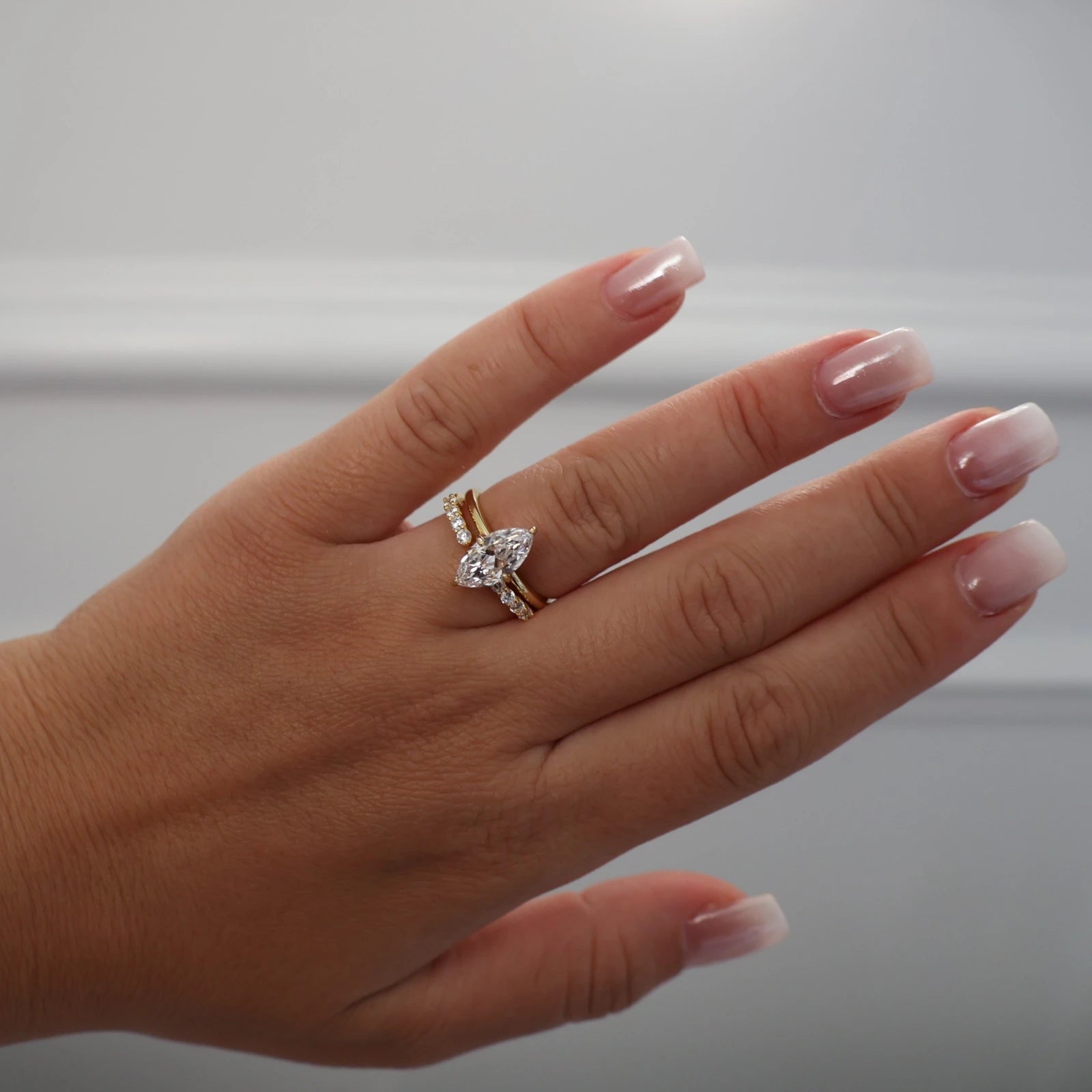 marquise CZ gold solitaire ring stacked with open band
