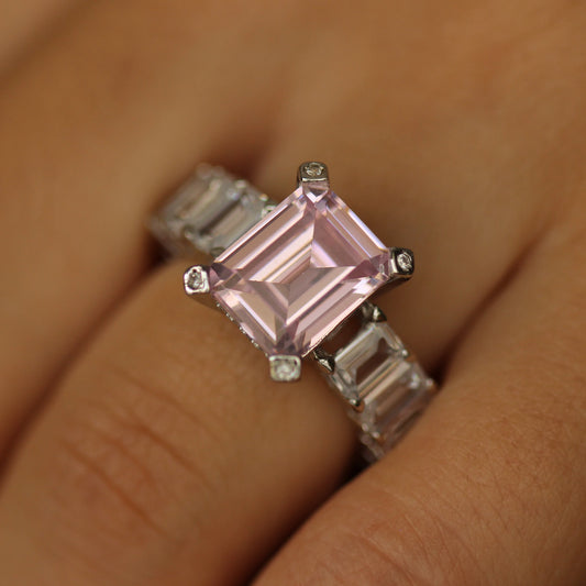 pink emerald ring with baguette side stones on hand