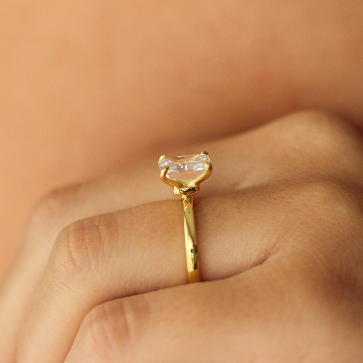 plain gold ring with 2 carat rectangle cubic zirconia centre stone on hand side profile