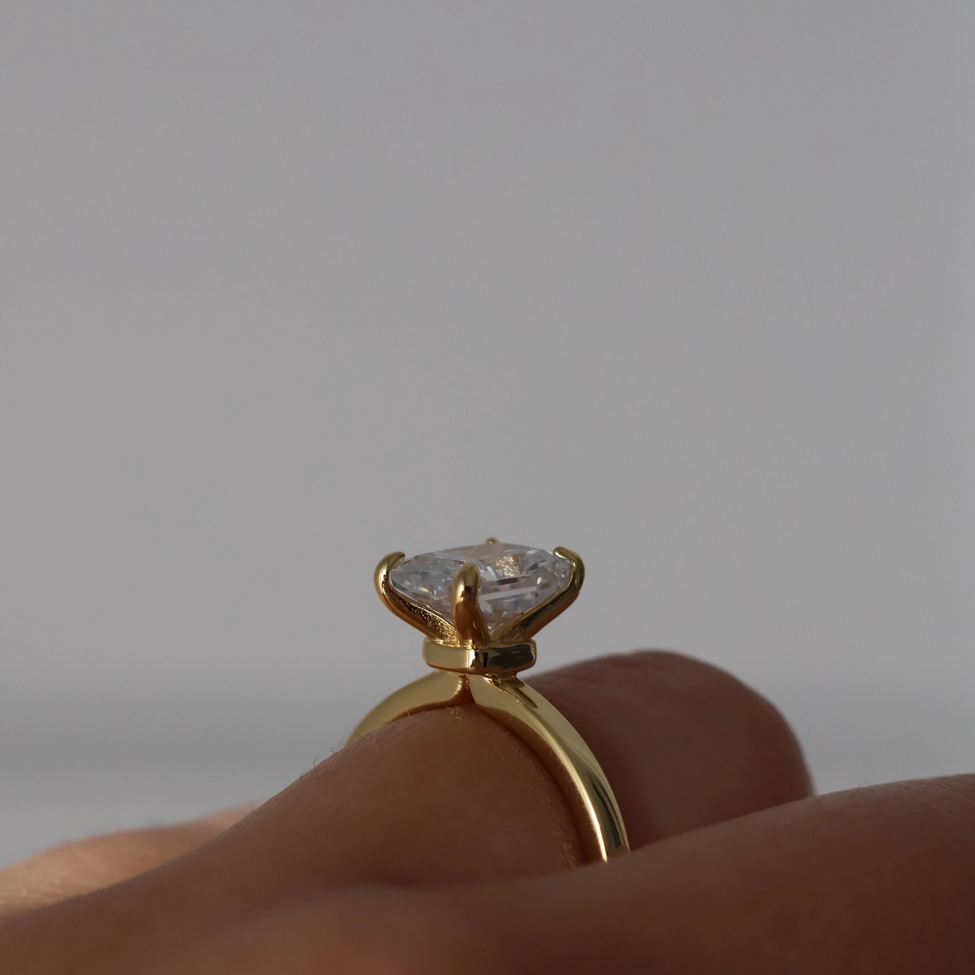 plain gold ring with 2 carat rectangle cubic zirconia centre stone on hand side profile