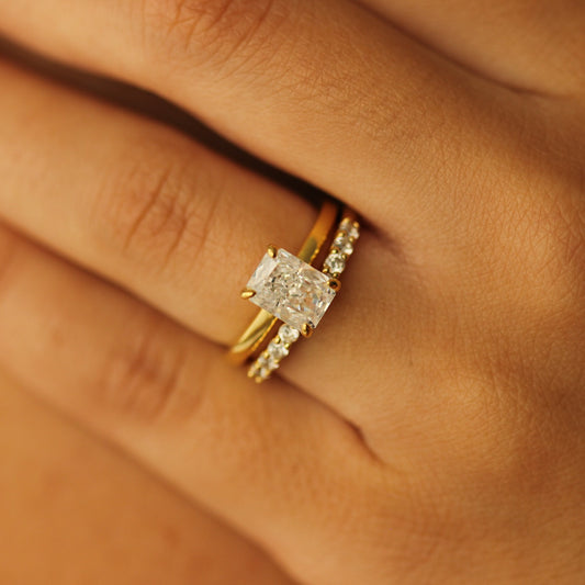 plain gold ring with 2 carat rectangle cubic zirconia centre stone on hand with gold open ring