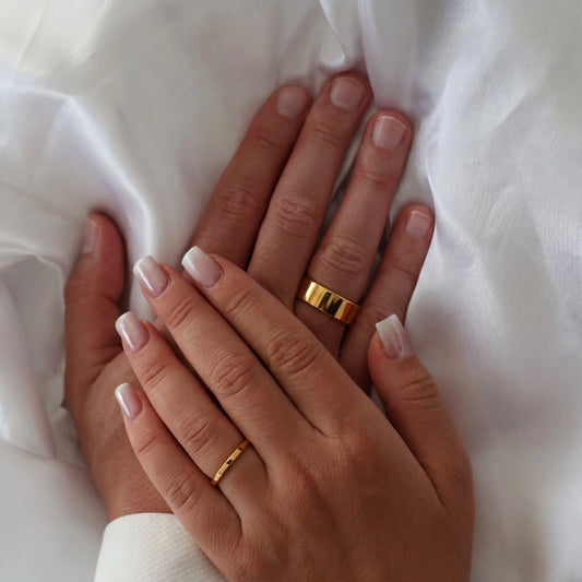 men’s 8mm polished gold flat wedding band on hand