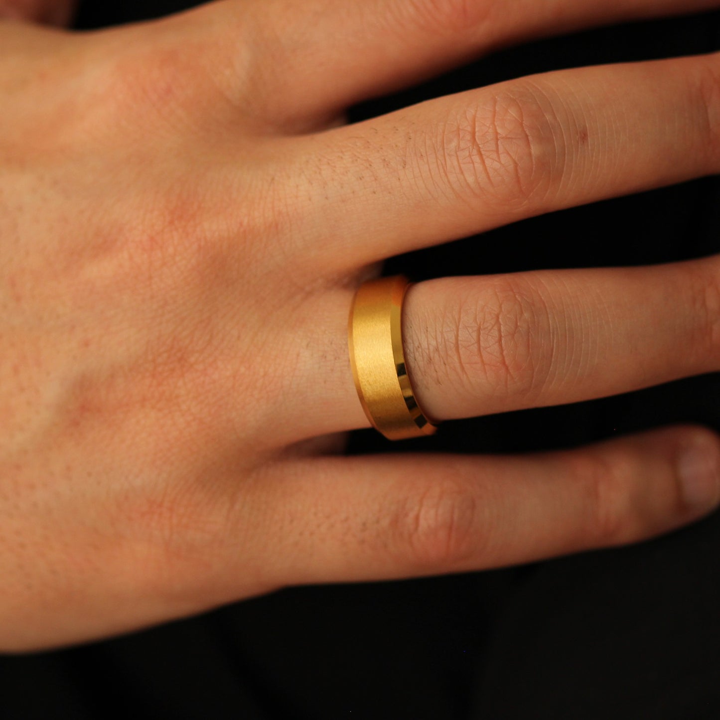 Men’s gold wedding band with beveled edges