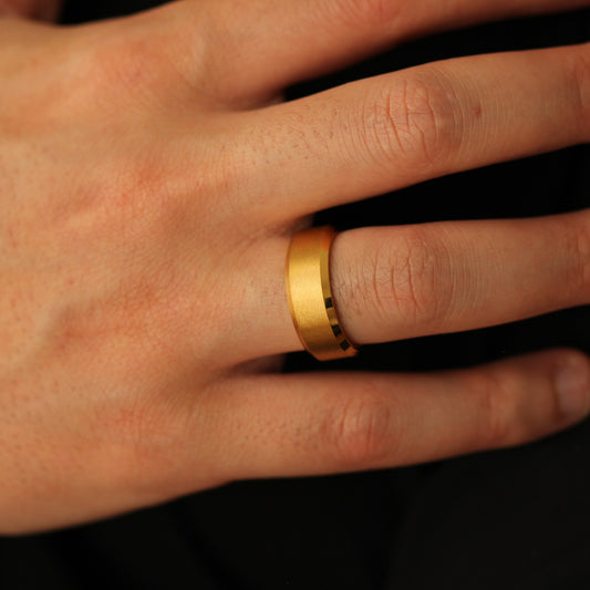 Men’s gold wedding band with beveled edges