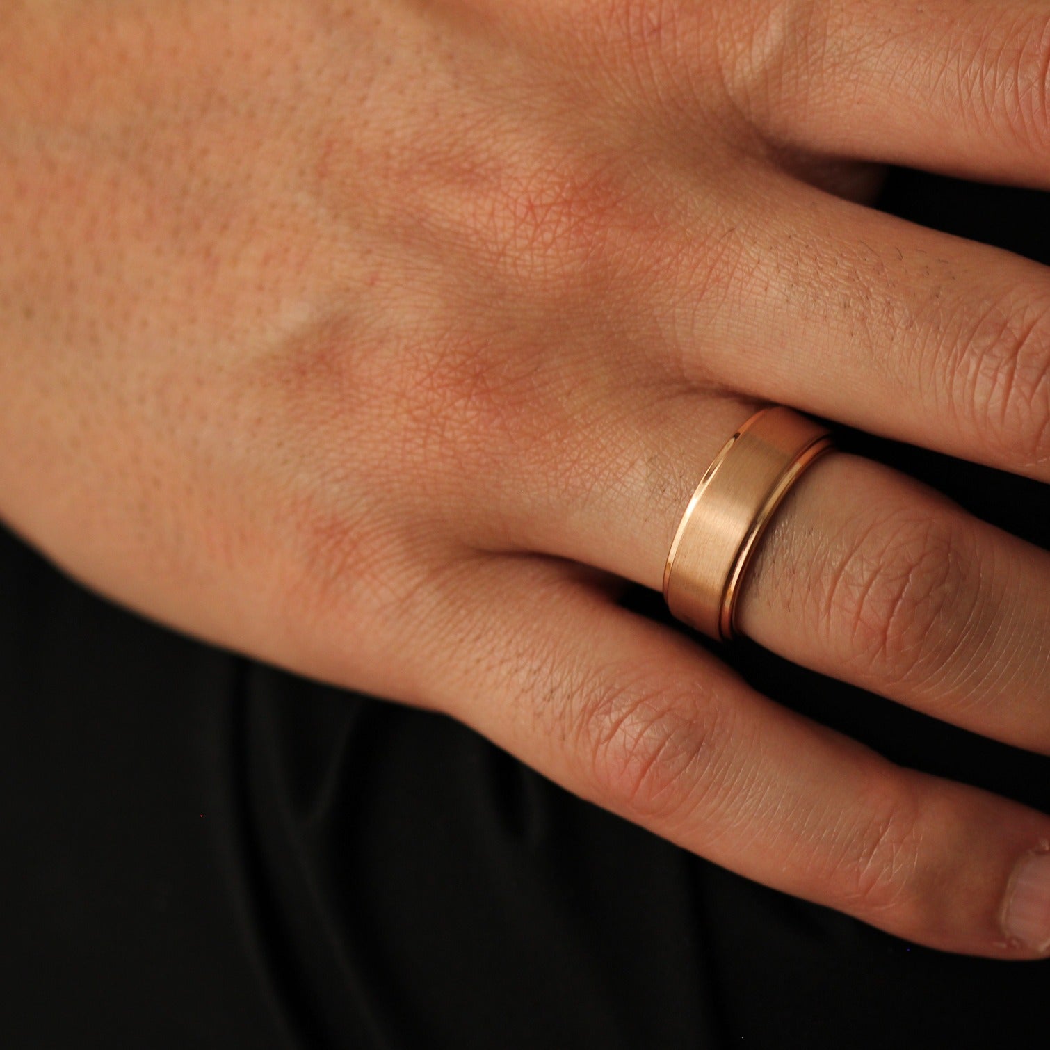 Men’s rose gold wedding band with stepped edges