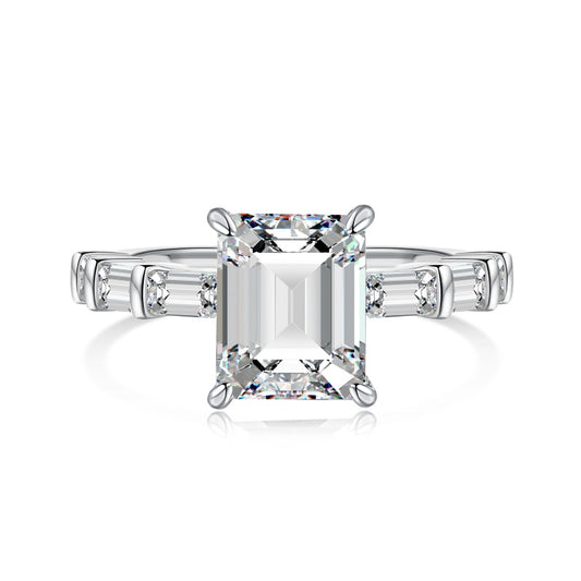 miami emerald ring with baguette side stones on white background