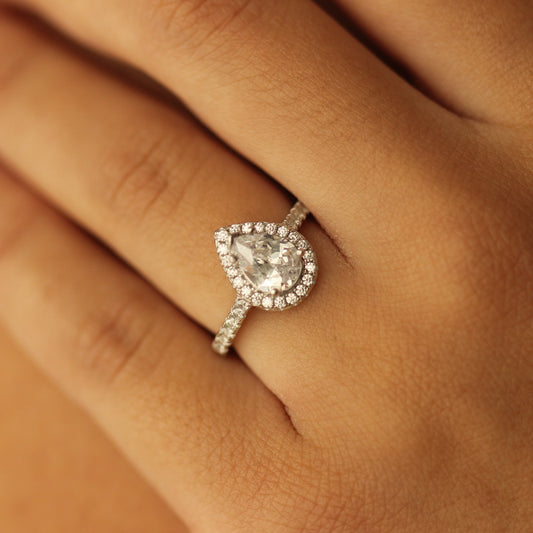 pear halo ring with pave band on hand